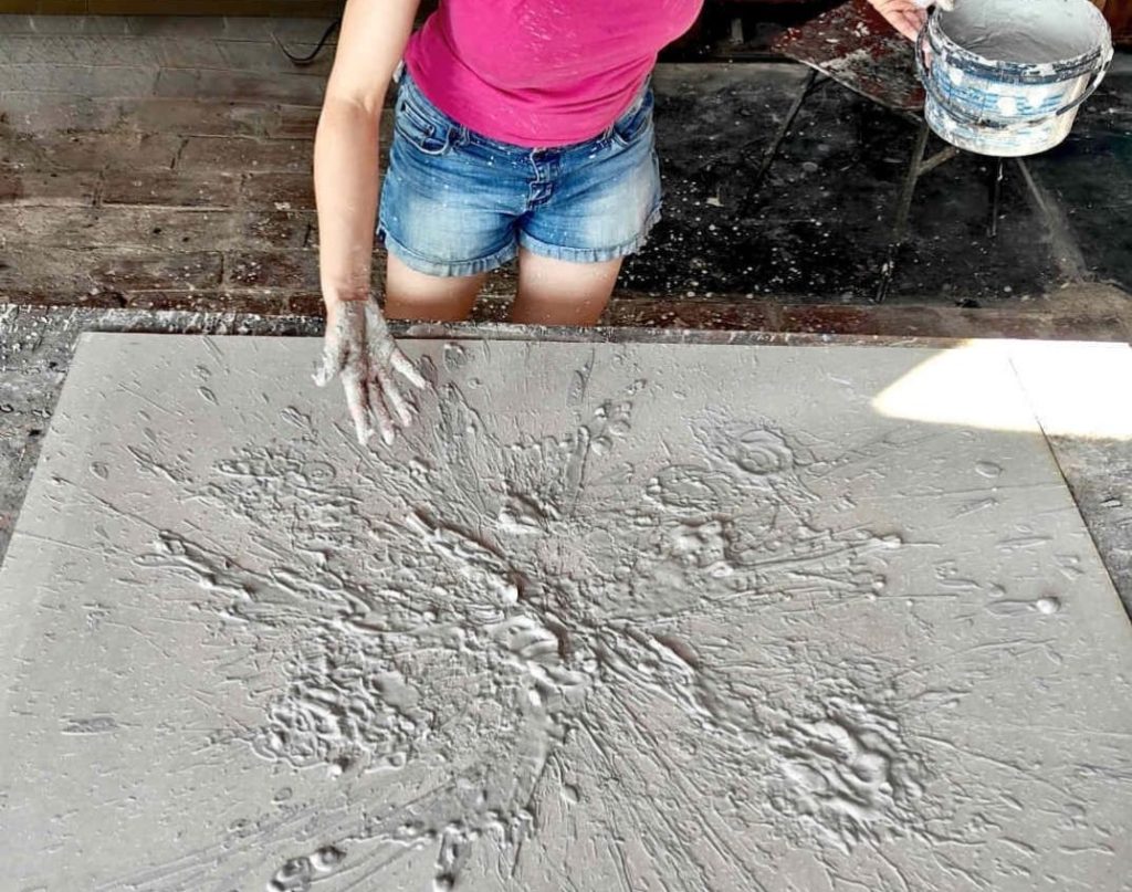 BelA ALeksandra in her artistic process creating textural paintings inspired by Vinca civilization